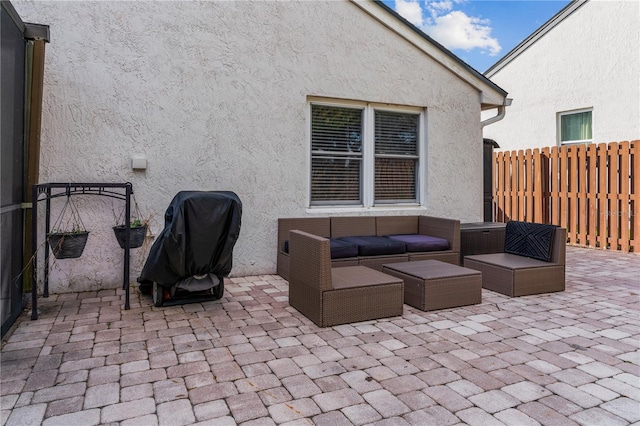 view of patio featuring fence, an outdoor living space, and area for grilling