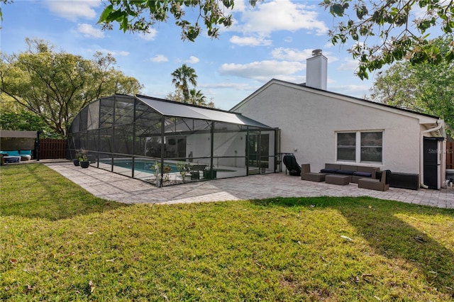 back of property with a lawn, a patio, fence, outdoor lounge area, and stucco siding