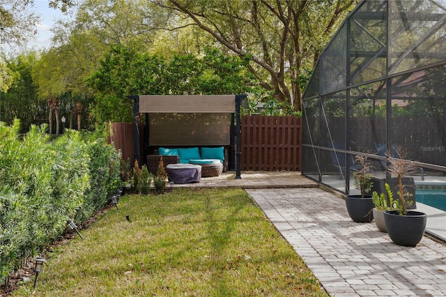 view of yard with a patio, a fenced backyard, glass enclosure, and a fenced in pool