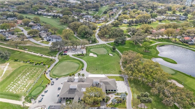 birds eye view of property featuring view of golf course and a water view