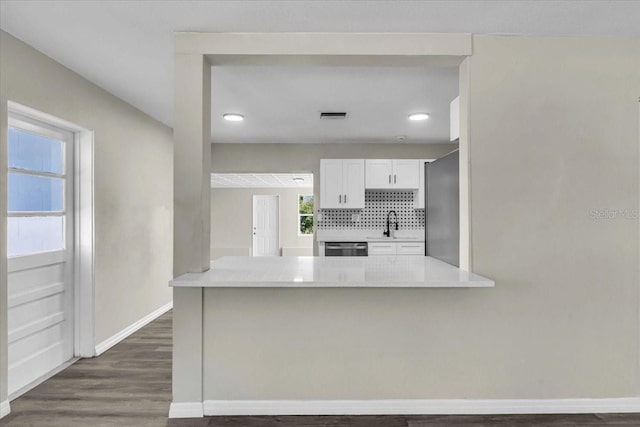 kitchen with tasteful backsplash, visible vents, light countertops, appliances with stainless steel finishes, and white cabinetry