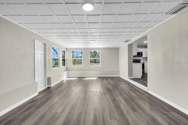 interior space with dark wood-style floors, baseboards, and visible vents