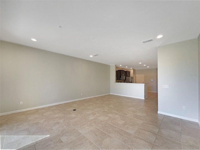 empty room featuring light tile patterned floors, visible vents, recessed lighting, and baseboards