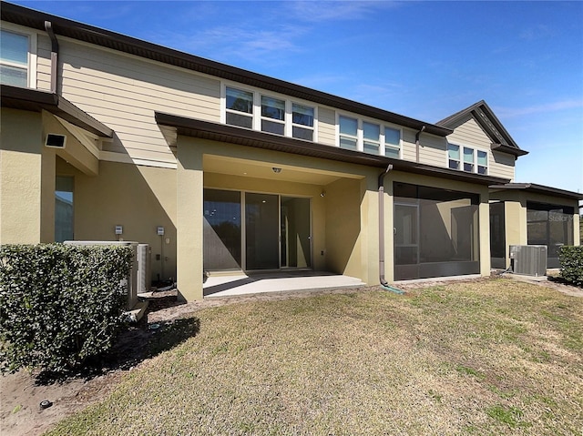 rear view of house with cooling unit and stucco siding