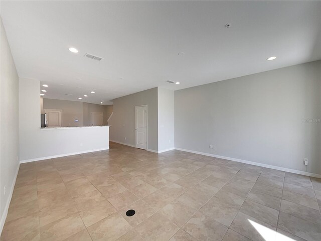 unfurnished room with recessed lighting, visible vents, and baseboards