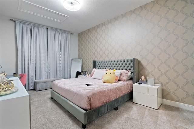 bedroom featuring baseboards, a textured ceiling, and wallpapered walls