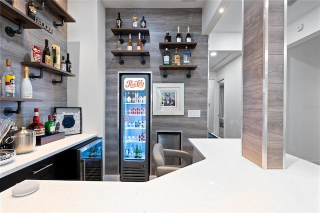 bar featuring a dry bar, wine cooler, and wood walls