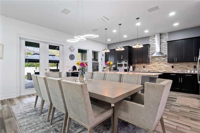 dining room with french doors, recessed lighting, visible vents, light wood-style floors, and baseboards