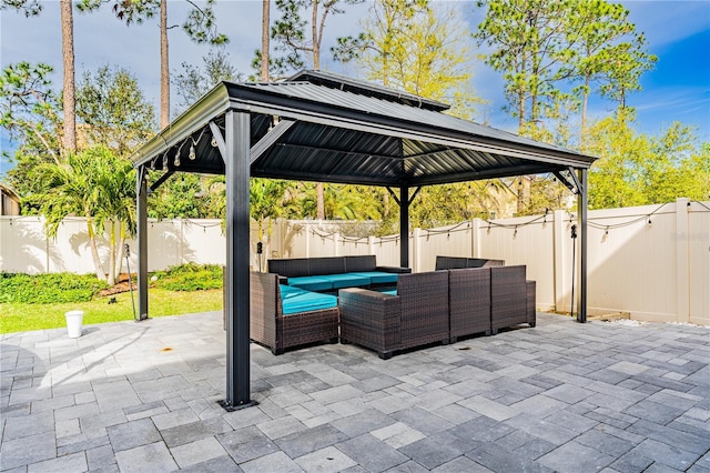 view of patio featuring an outdoor hangout area, a gazebo, and a fenced backyard