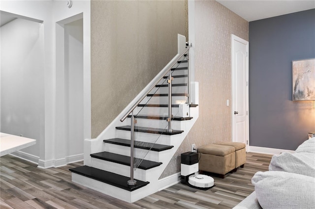 stairs featuring baseboards and wood finished floors