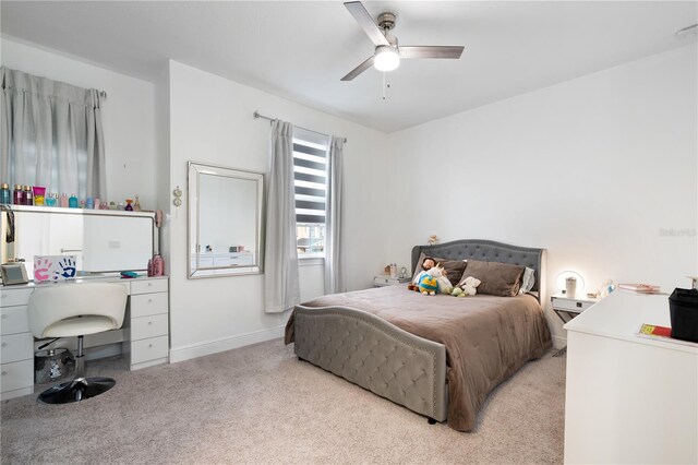 bedroom with ceiling fan, baseboards, and light colored carpet