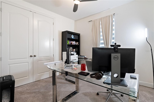 carpeted home office featuring a ceiling fan