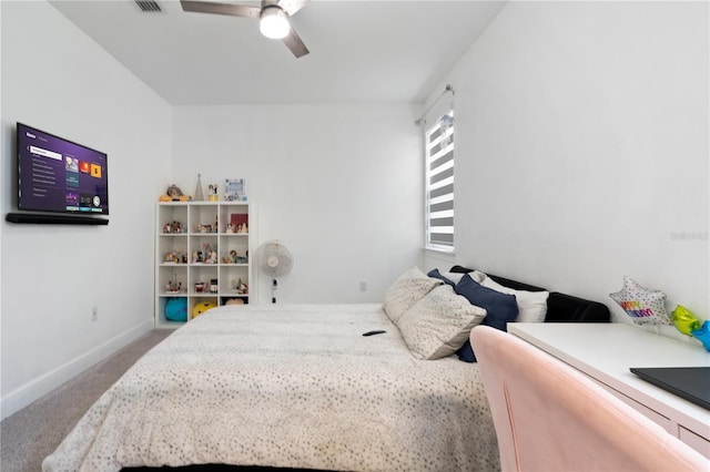 carpeted bedroom with ceiling fan and baseboards