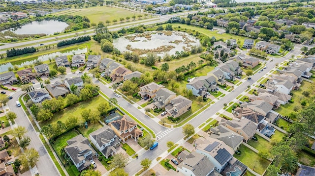 bird's eye view with a water view and a residential view