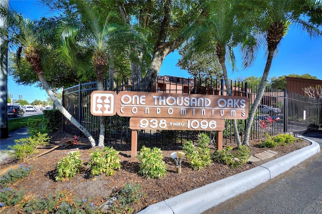 community sign featuring fence