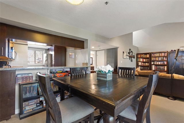 dining area featuring light carpet