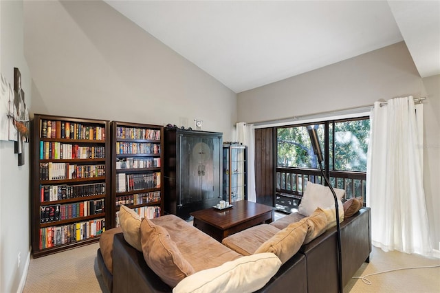 living room featuring lofted ceiling and light colored carpet