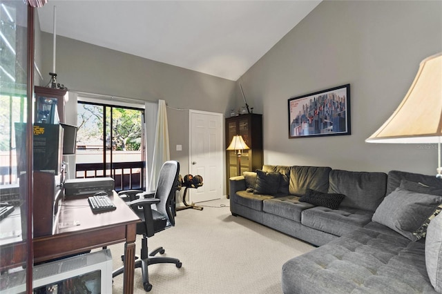 home office with high vaulted ceiling and carpet flooring