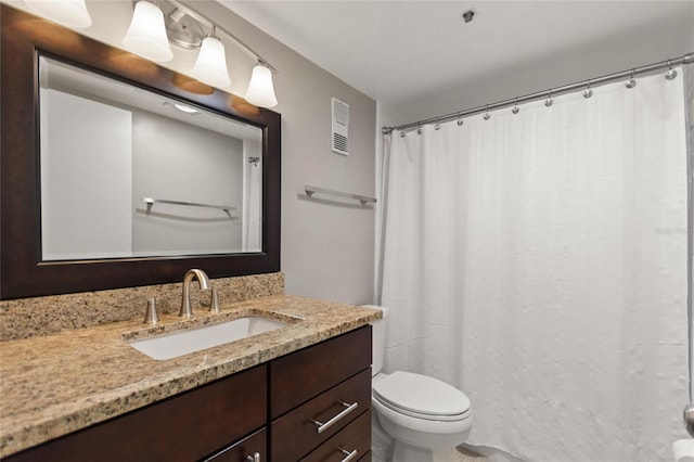 bathroom featuring visible vents, vanity, and toilet