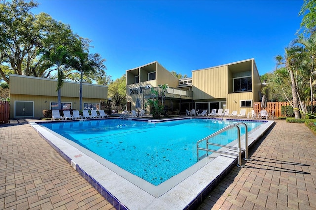 pool featuring fence and a patio