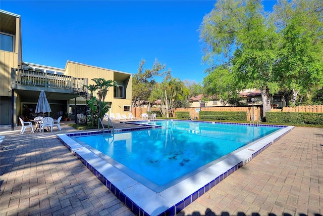 community pool featuring a patio area and fence