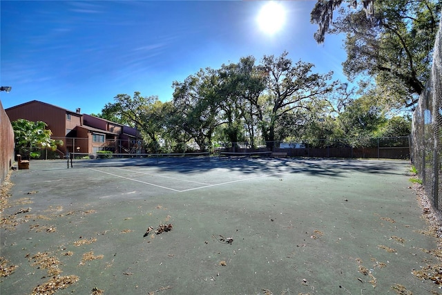 view of tennis court featuring fence