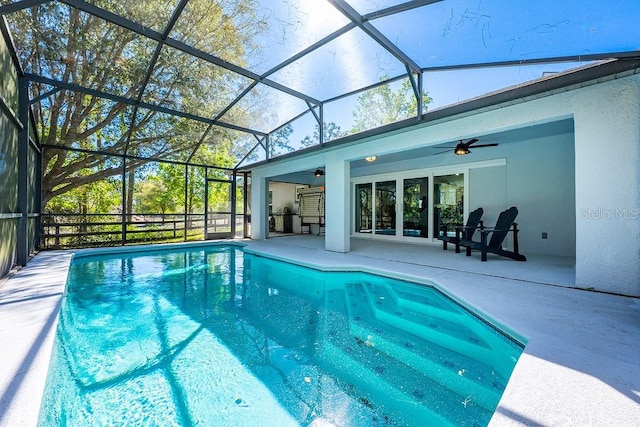 view of pool with a lanai, a patio, and ceiling fan