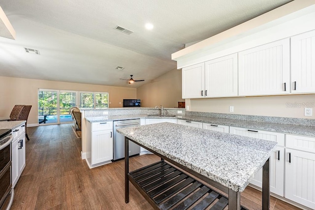 kitchen with a peninsula, visible vents, appliances with stainless steel finishes, and a sink