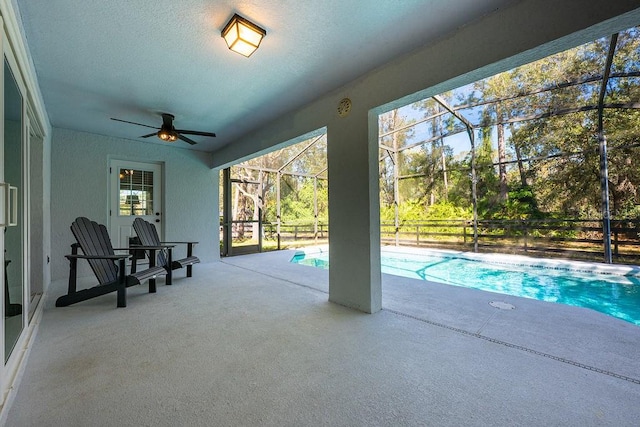 outdoor pool featuring a patio, a lanai, and ceiling fan