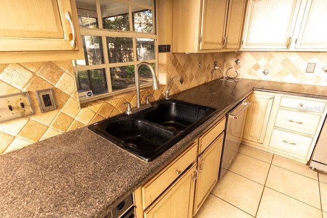 kitchen with a sink, backsplash, stainless steel dishwasher, and light tile patterned floors