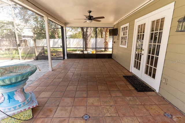 unfurnished sunroom with french doors and a ceiling fan