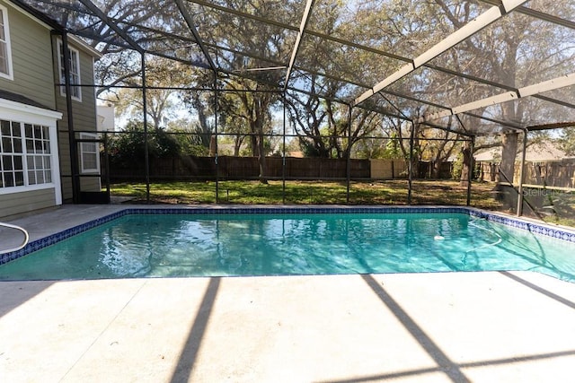 view of pool with a patio area, glass enclosure, a fenced backyard, and a fenced in pool