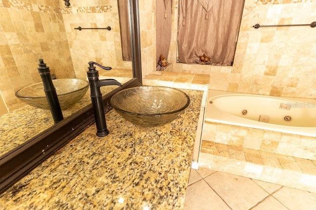 bathroom featuring tile patterned flooring, tile walls, and a tub with jets