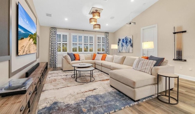 living room featuring baseboards, visible vents, wood finished floors, vaulted ceiling, and recessed lighting