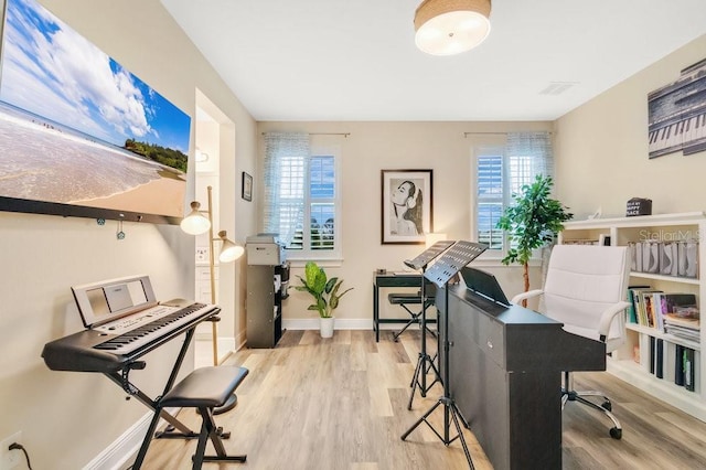 office space with baseboards and wood finished floors