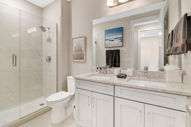 full bath featuring double vanity, a sink, toilet, and a shower stall