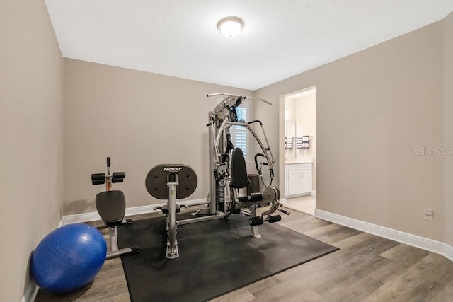 workout room with wood finished floors and baseboards