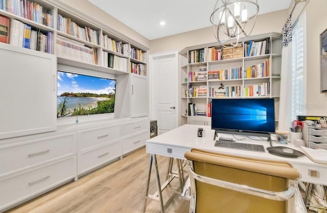 office area featuring light wood-style floors, recessed lighting, and an inviting chandelier