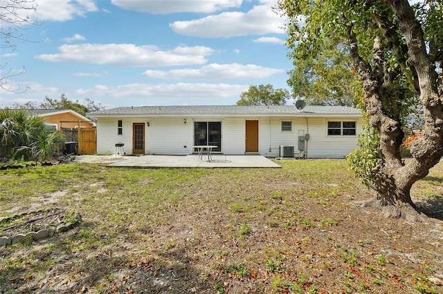 rear view of house with a yard, a patio, fence, and central AC unit