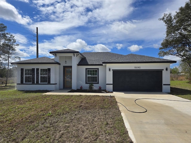 view of front of house featuring a front lawn, concrete driveway, an attached garage, and stucco siding