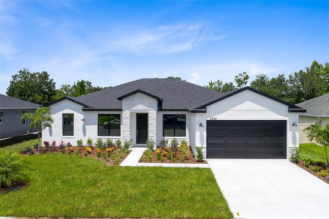 view of front of house featuring stucco siding, driveway, roof with shingles, an attached garage, and a front yard