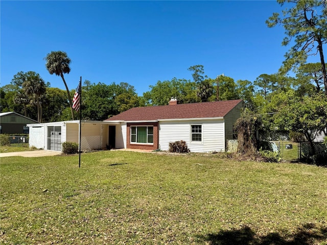 view of front of home with a front lawn, fence, concrete driveway, a chimney, and an attached garage