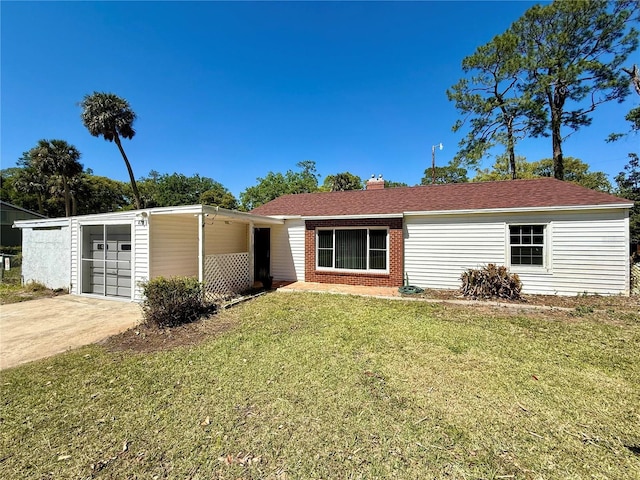 ranch-style home featuring concrete driveway, a front yard, a shingled roof, a garage, and a chimney