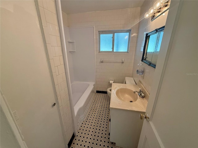 full bath featuring tile patterned floors, toilet, tile walls, and vanity