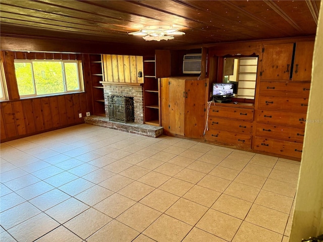 unfurnished living room with light tile patterned floors, built in features, wood ceiling, and wood walls