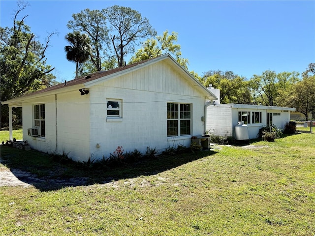 view of property exterior with a yard and cooling unit