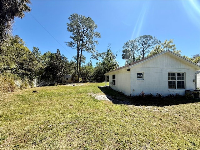 view of side of property with a yard