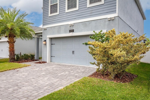 garage with decorative driveway