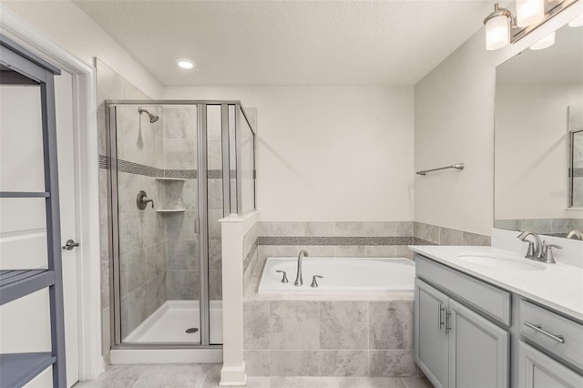 full bath with a garden tub, a shower stall, and vanity