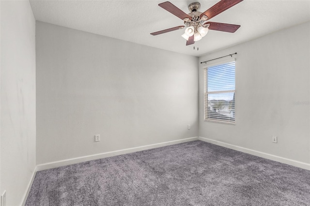 carpeted empty room with ceiling fan, a textured ceiling, and baseboards